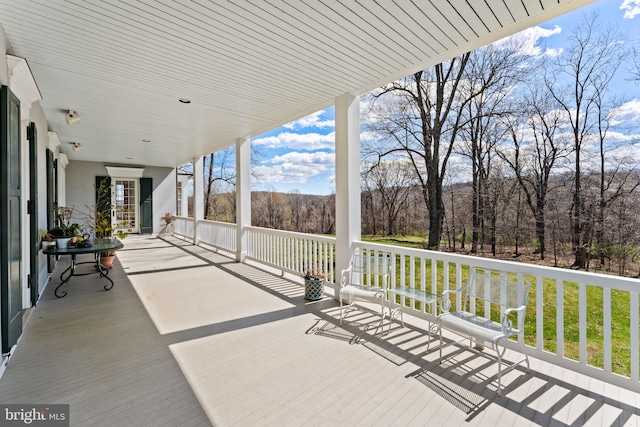 wooden terrace featuring a lawn