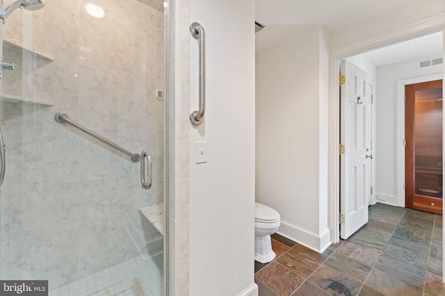 bathroom with toilet, tile flooring, and an enclosed shower