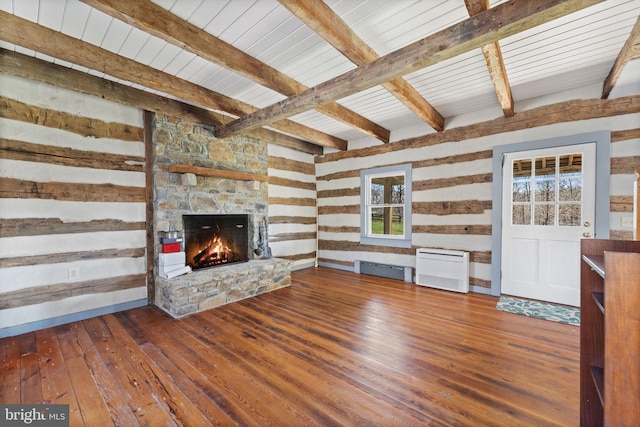 unfurnished living room featuring a stone fireplace, dark hardwood / wood-style floors, and beamed ceiling