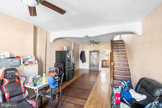 living room featuring dark hardwood / wood-style flooring and ceiling fan