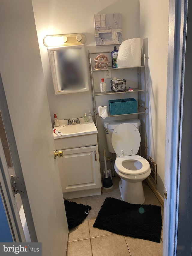 bathroom with vanity, tile flooring, and toilet