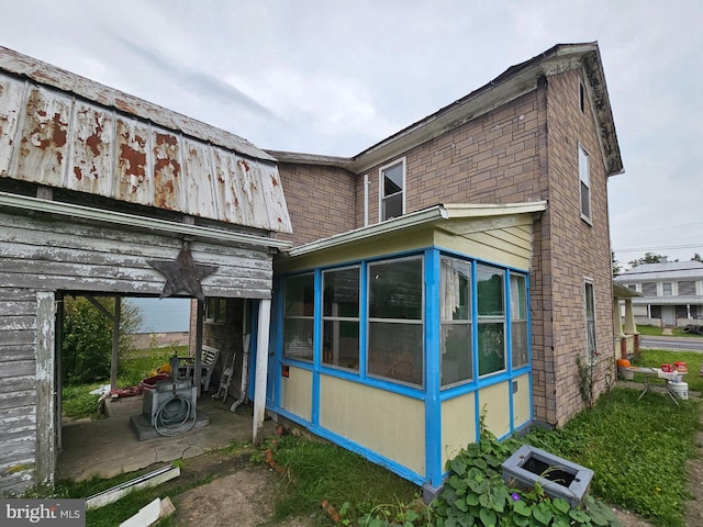 back of property featuring a sunroom