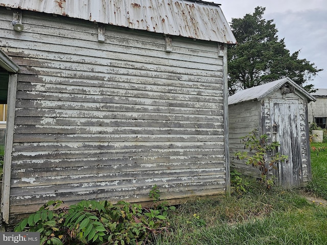 view of property exterior with a storage shed