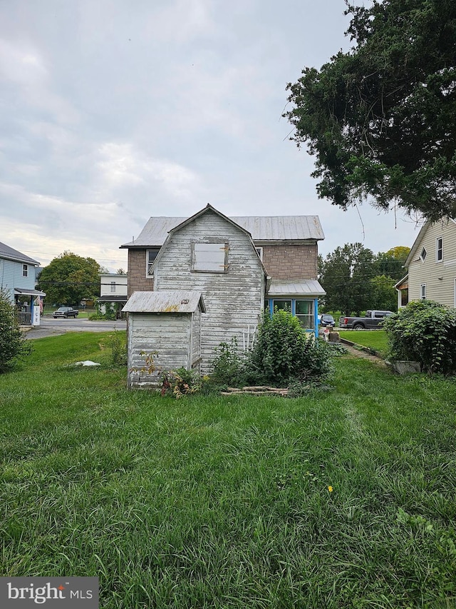 view of side of property with a yard