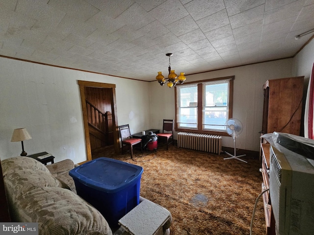 living room with crown molding, dark colored carpet, an inviting chandelier, and radiator heating unit