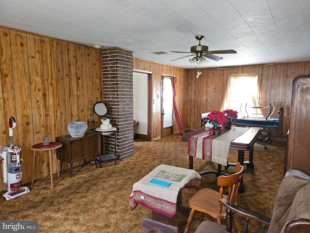 bedroom with brick wall, dark carpet, and wooden walls