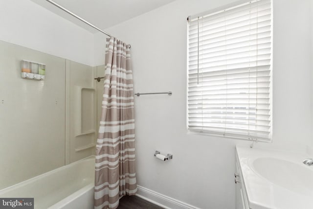 bathroom featuring shower / bath combo and a healthy amount of sunlight