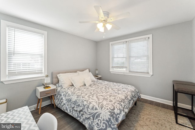 bedroom with ceiling fan and dark hardwood / wood-style flooring