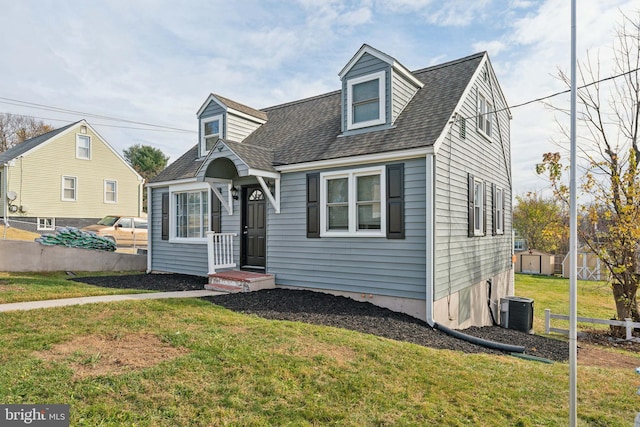 new england style home featuring a front yard and central AC