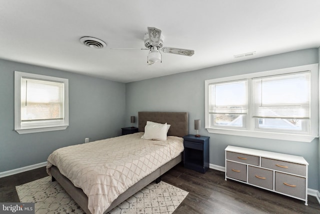 bedroom with dark hardwood / wood-style flooring and ceiling fan