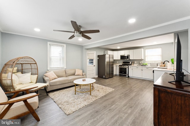 living room featuring crown molding, dark hardwood / wood-style flooring, a healthy amount of sunlight, and sink