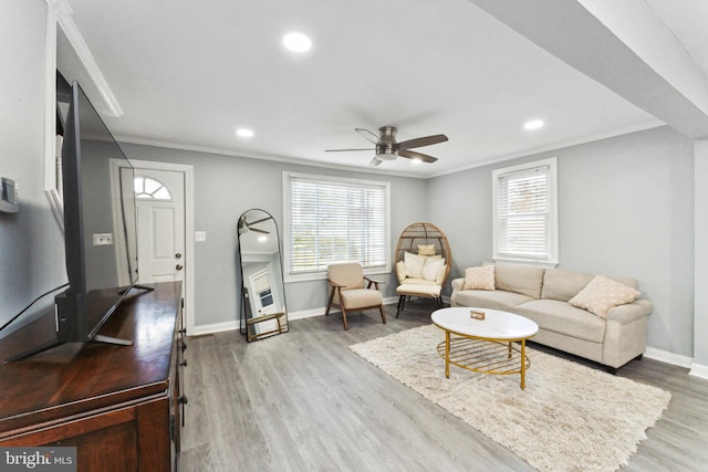 living room with ceiling fan, hardwood / wood-style floors, and ornamental molding