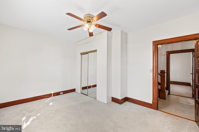 unfurnished bedroom with light tile floors, a closet, and ceiling fan