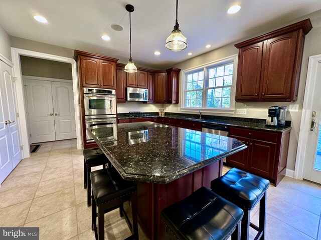 kitchen featuring a breakfast bar area, recessed lighting, appliances with stainless steel finishes, and pendant lighting