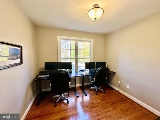 home office featuring baseboards and wood finished floors