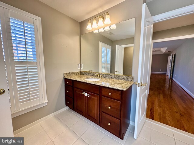 bathroom featuring tile patterned floors, vanity, and baseboards