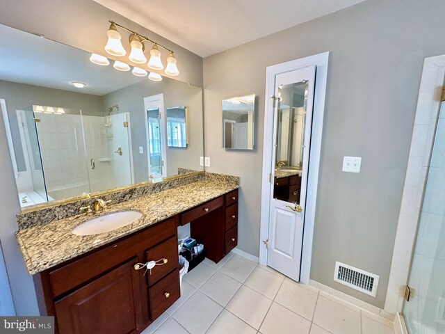 full bath with visible vents, baseboards, a stall shower, tile patterned floors, and vanity