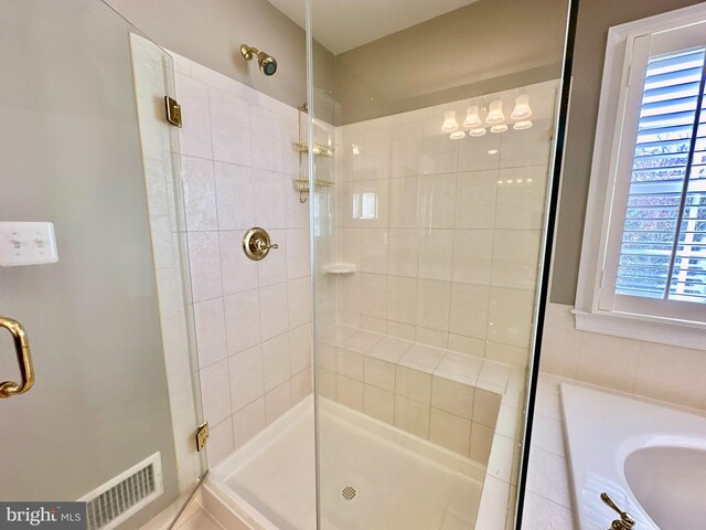 bathroom featuring visible vents and a stall shower