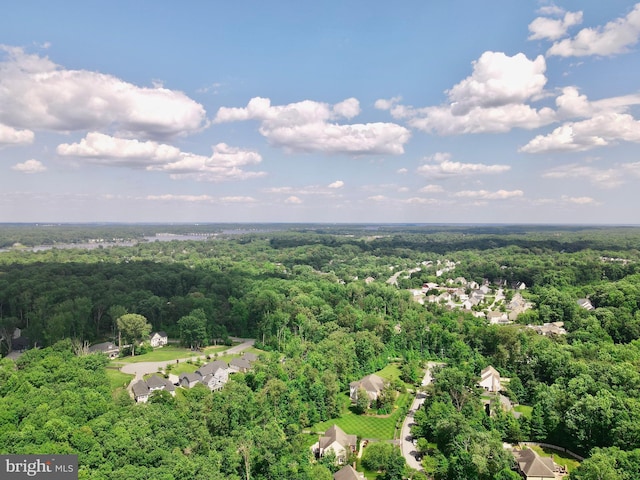 birds eye view of property featuring a wooded view