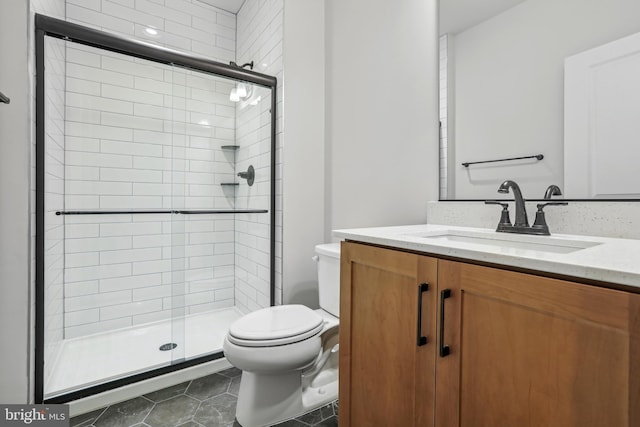 bathroom with tile floors, walk in shower, toilet, and vanity