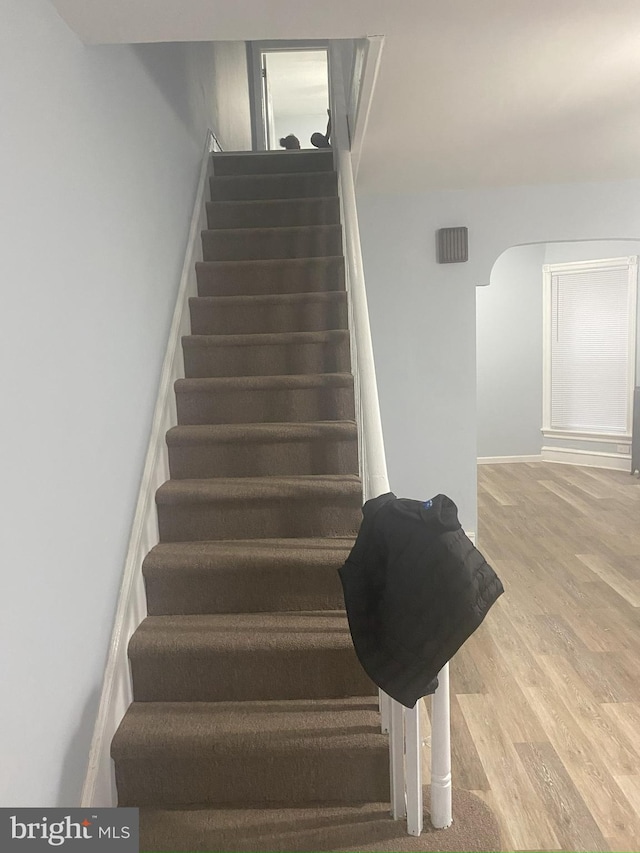 staircase with light hardwood / wood-style flooring