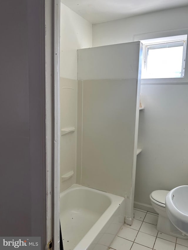 bathroom featuring tile flooring and toilet