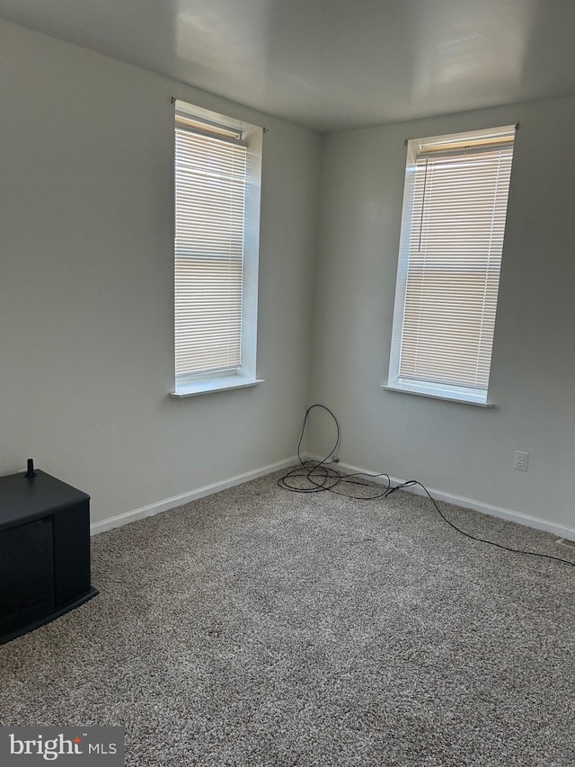 carpeted empty room featuring plenty of natural light