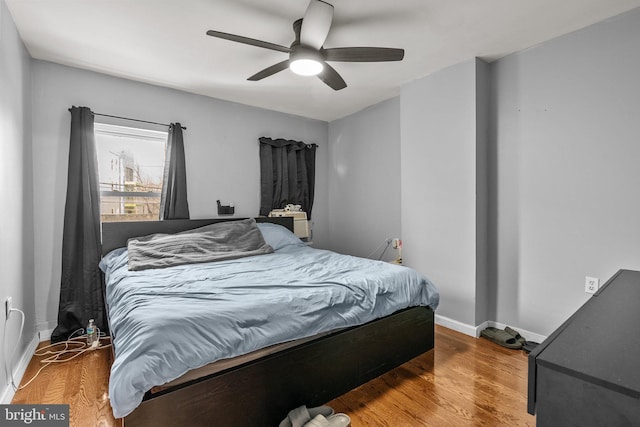 bedroom with ceiling fan and hardwood / wood-style floors