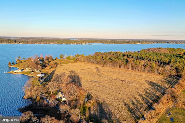 aerial view at dusk featuring a water view