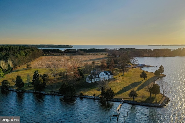 aerial view at dusk with a rural view and a water view