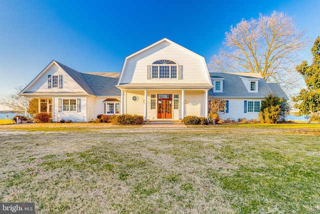 view of front of house with covered porch and a front yard