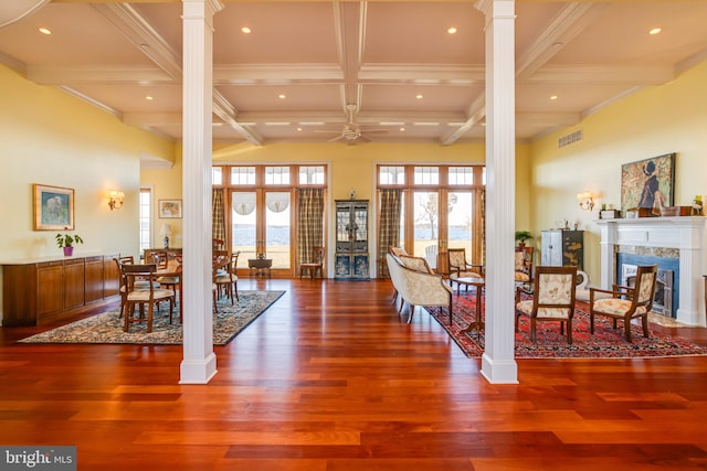 interior space with decorative columns, beamed ceiling, and french doors