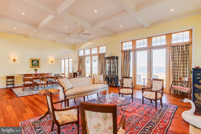 living room featuring coffered ceiling, hardwood / wood-style floors, beam ceiling, and french doors