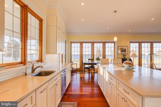 kitchen featuring crown molding, sink, decorative light fixtures, and dark wood-type flooring