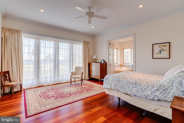 bedroom with multiple windows, hardwood / wood-style floors, crown molding, and ceiling fan