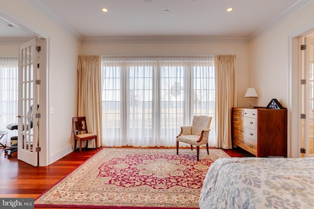 bedroom with ornamental molding and dark hardwood / wood-style floors