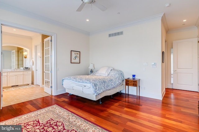 bedroom with crown molding, ceiling fan, and light hardwood / wood-style flooring