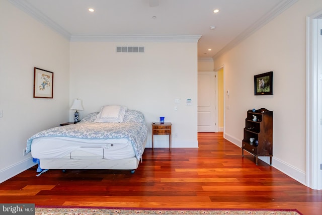 bedroom featuring crown molding and wood-type flooring