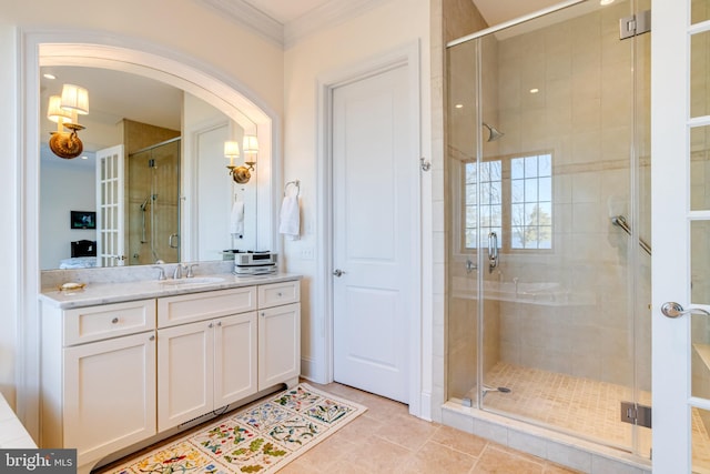 bathroom with walk in shower, ornamental molding, vanity, and tile patterned flooring