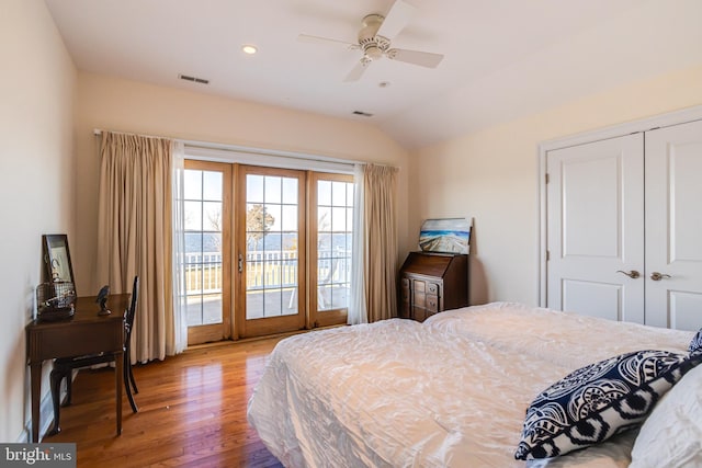 bedroom featuring ceiling fan, vaulted ceiling, wood-type flooring, access to outside, and a closet