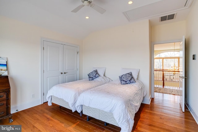 bedroom featuring vaulted ceiling, ceiling fan, hardwood / wood-style floors, and a closet