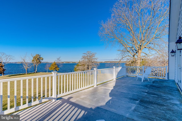 deck featuring a yard and a water view