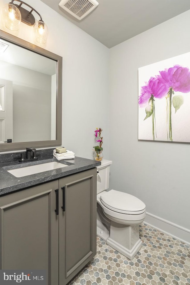 bathroom with vanity, tile flooring, and toilet