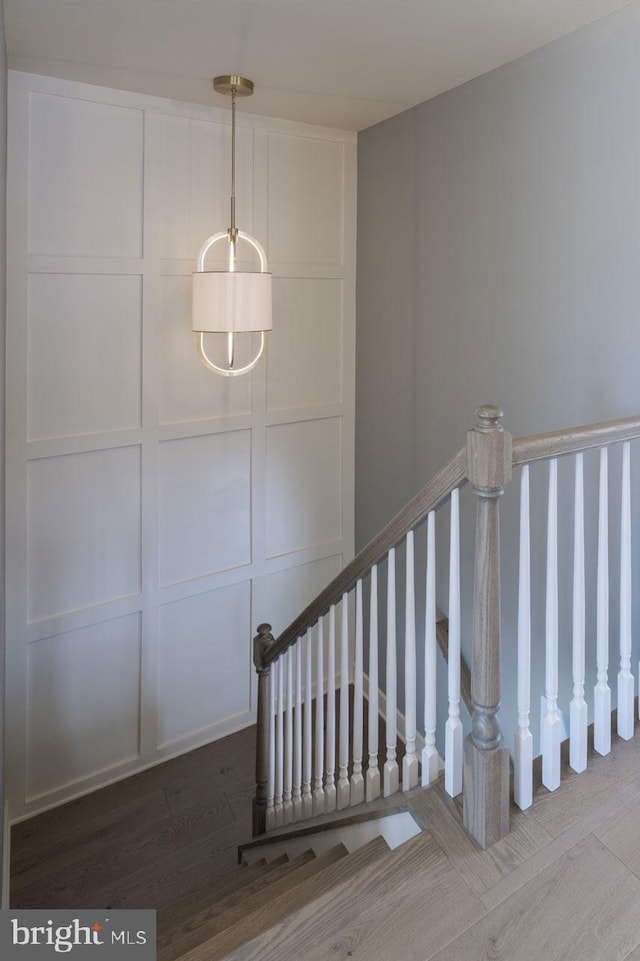 staircase with hardwood / wood-style flooring