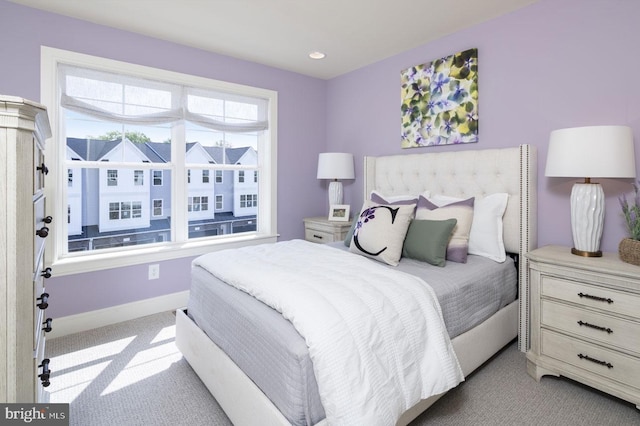 bedroom featuring light colored carpet