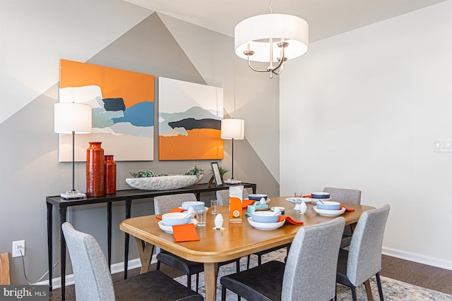 dining space with a notable chandelier and hardwood / wood-style flooring