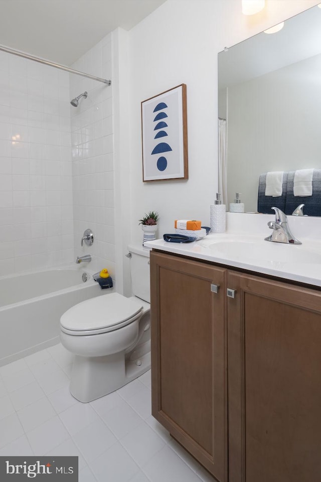 full bathroom featuring vanity, tile flooring, toilet, and tiled shower / bath