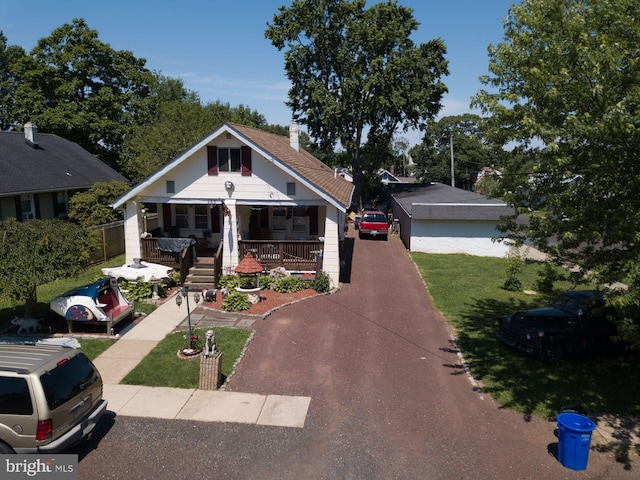 bungalow-style house with covered porch and a front yard