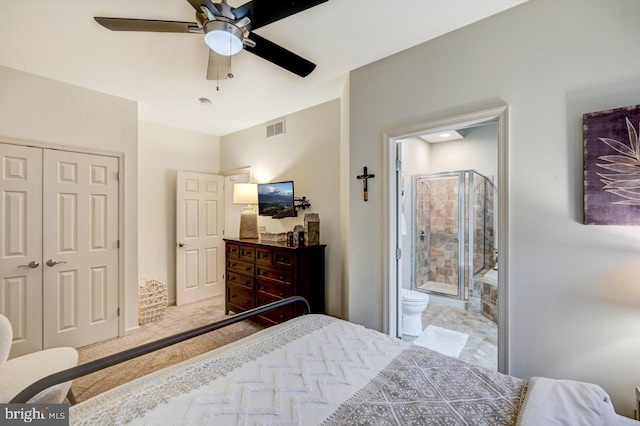 tiled bedroom featuring a closet, ensuite bathroom, and ceiling fan