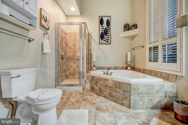 bathroom with tile flooring, toilet, and independent shower and bath